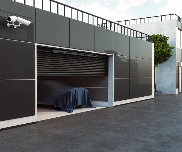 outdoor tiles for driveways - image of large tiled wall garage with car inside coved with dark coloured car cover with large dark floor tiles on driveway